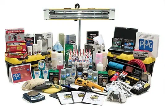 An assortment of automotive painting supplies for bumper repair, including spray guns, paint cans, masks, and sanding tools, displayed against a white background.